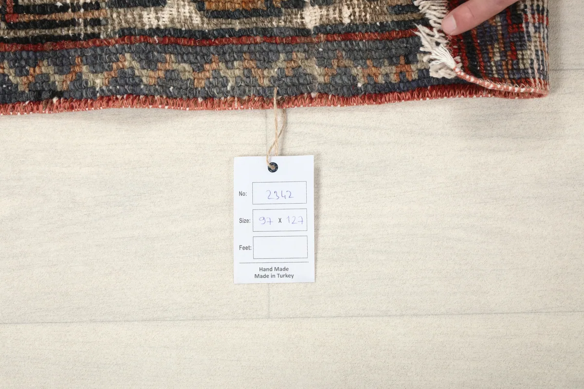 Faded Red Tribal Geometric Rug with a product tag displaying its size and origin.