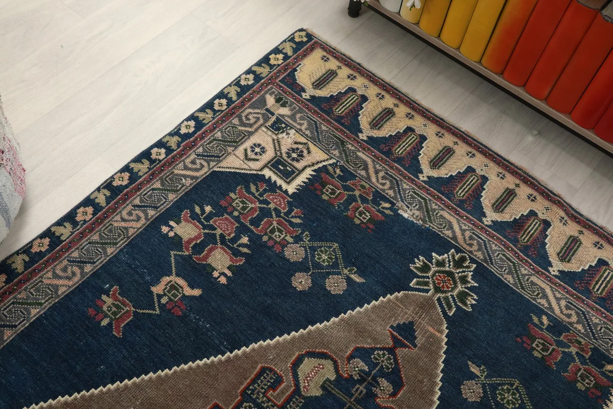 Close-up of the rug's border and corner motifs, showing texture and color variations