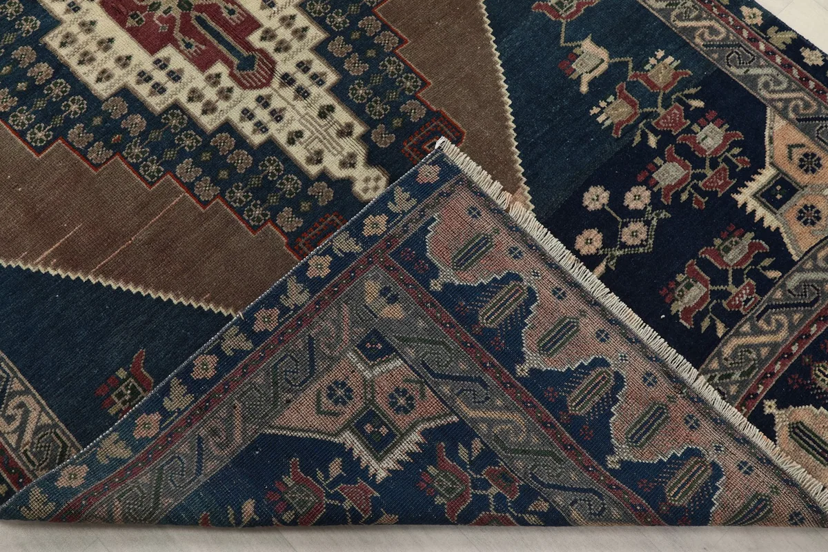 View of the rug's underside and folded corner, revealing its construction