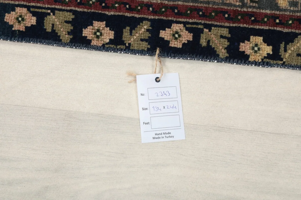 Label attached to the rug, indicating its size and origin