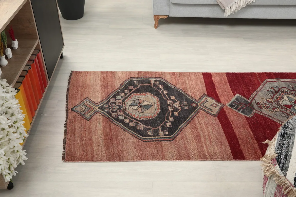 Overhead view of the runner's top half, showing the pattern progression and color variations in a room.