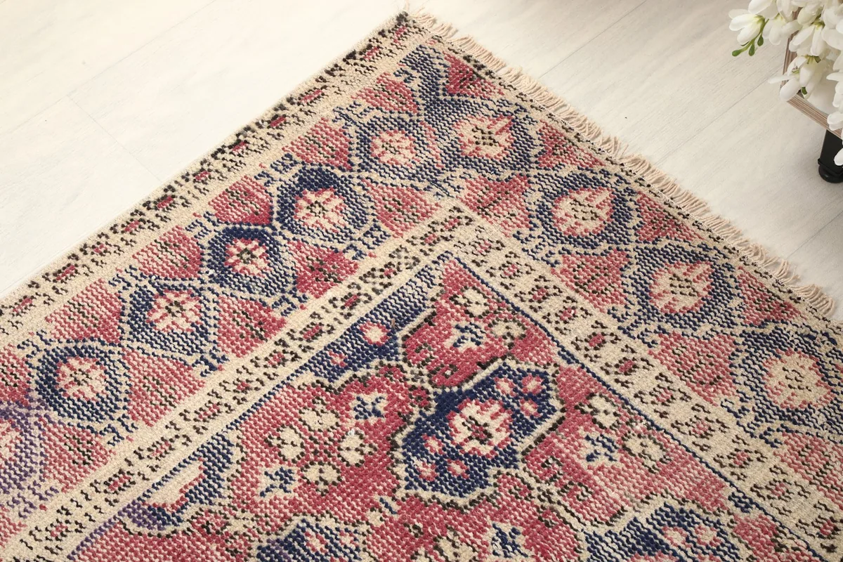 Corner detail of the rug, illustrating the border and field patterns