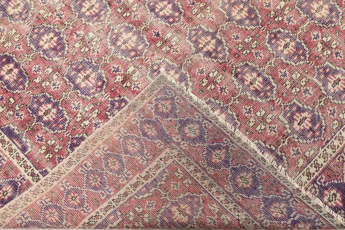 Folded corner of the rug showing the reverse side and knotting detail