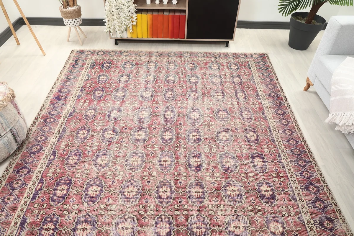 Overhead view of the vintage rug in a room, showing its full design and colors