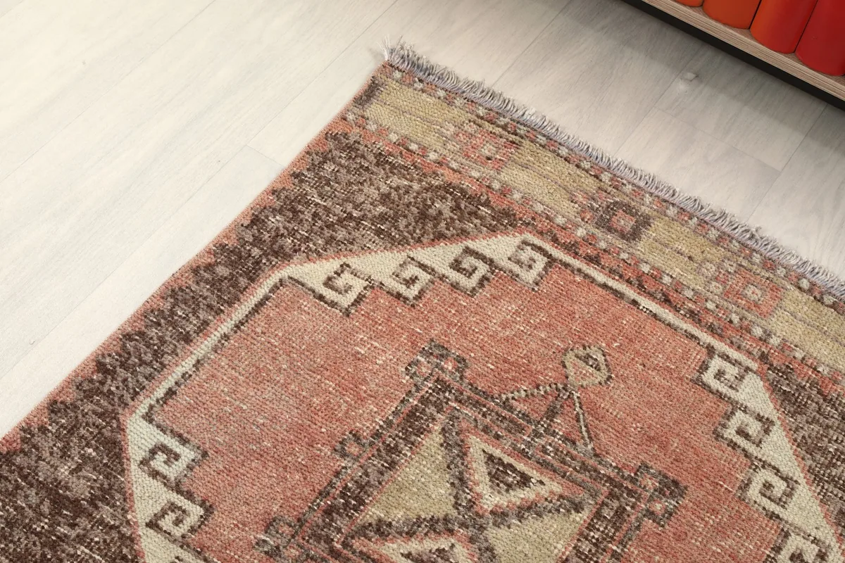 Detailed view of the rug's border and a corner, showing the geometric design
