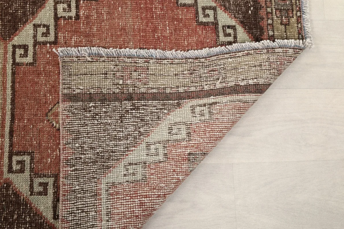 Reverse side of the runner rug, revealing the woven cotton foundation
