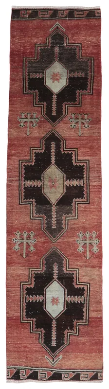 Full top view of a hand-knotted rust and black vintage Anatolian runner rug with geometric patterns