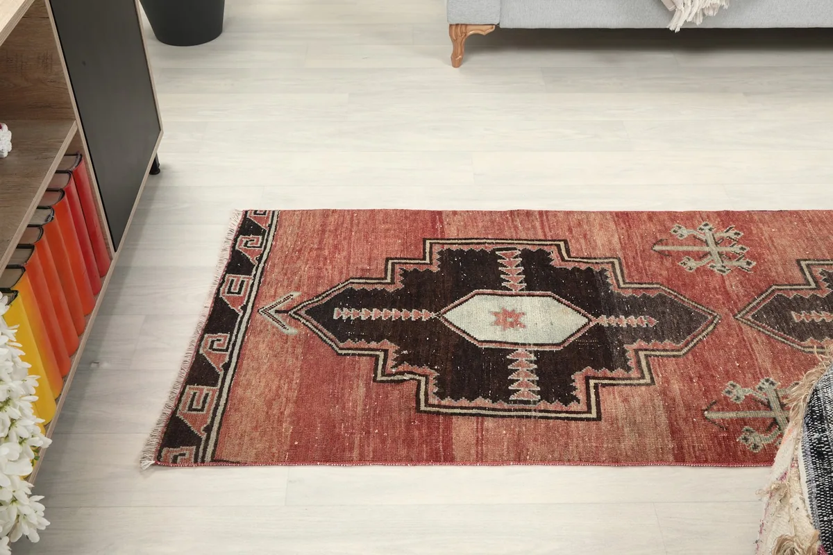 View of the rug's middle section, showcasing the distinct geometric shapes and color variations