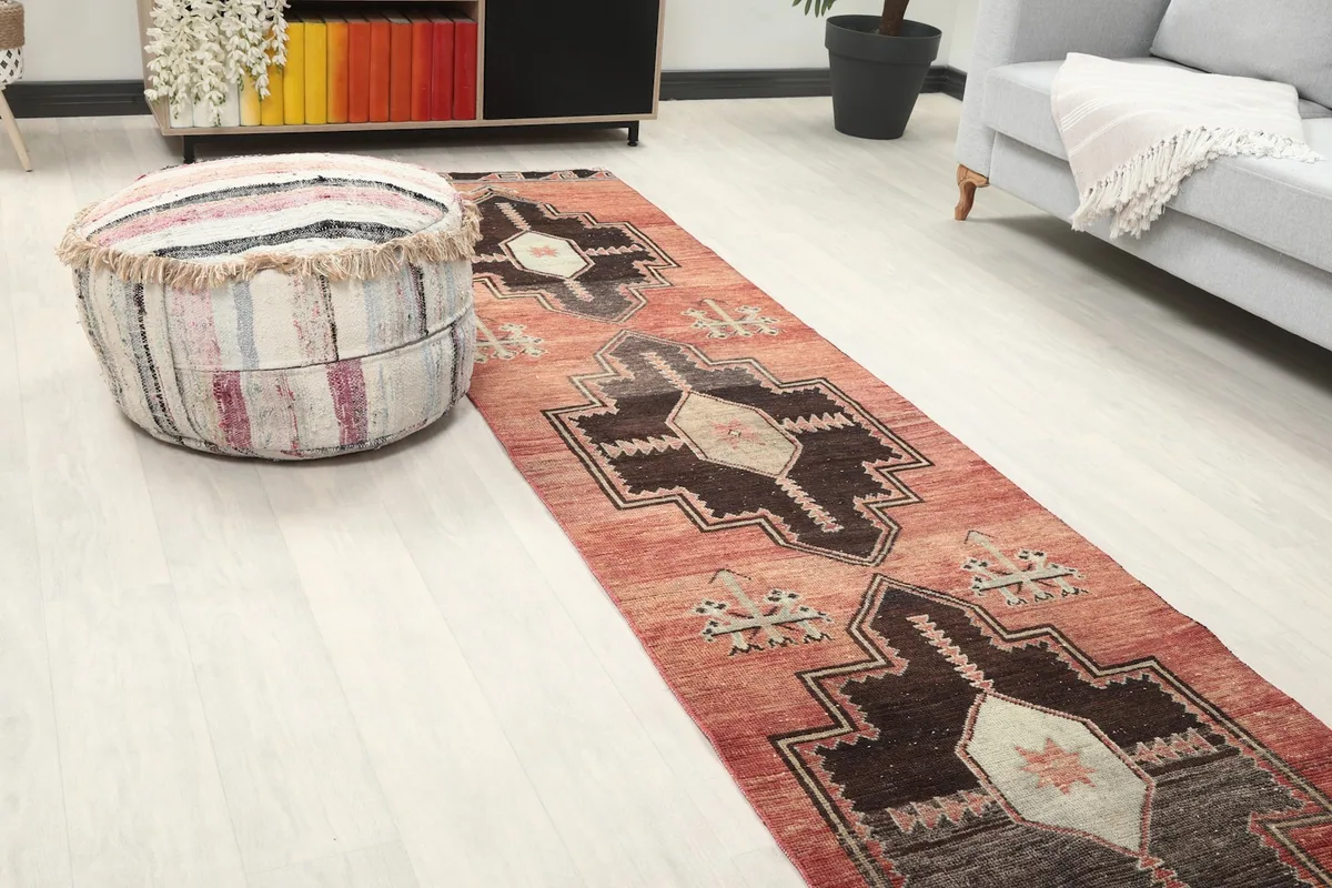 Close-up of the runner rug in a room, highlighting the central geometric motifs and colors