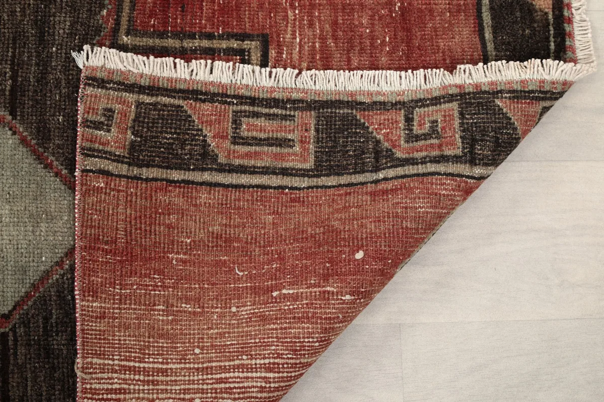 Close-up of the rug's back, revealing the intricate hand-knotting and foundation structure
