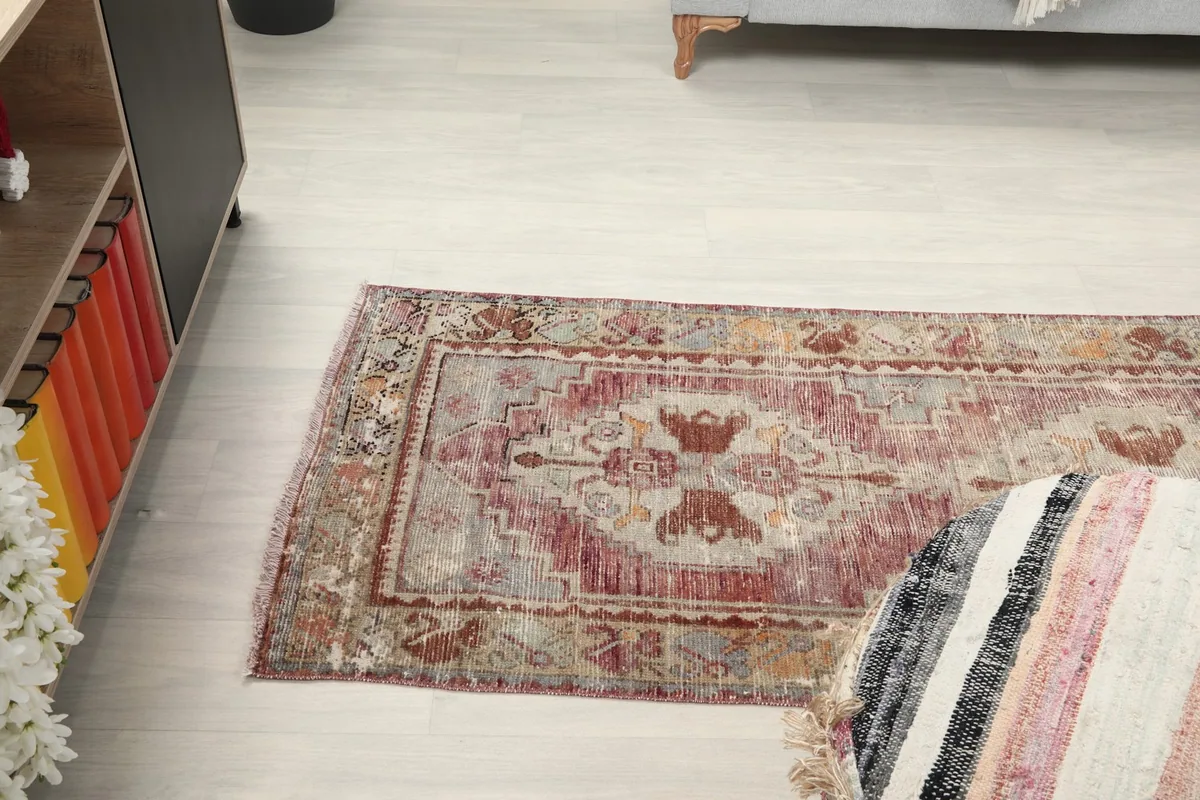 Angled view of the runner rug in the room setting, showing its long, narrow shape and how it complements the decor.
