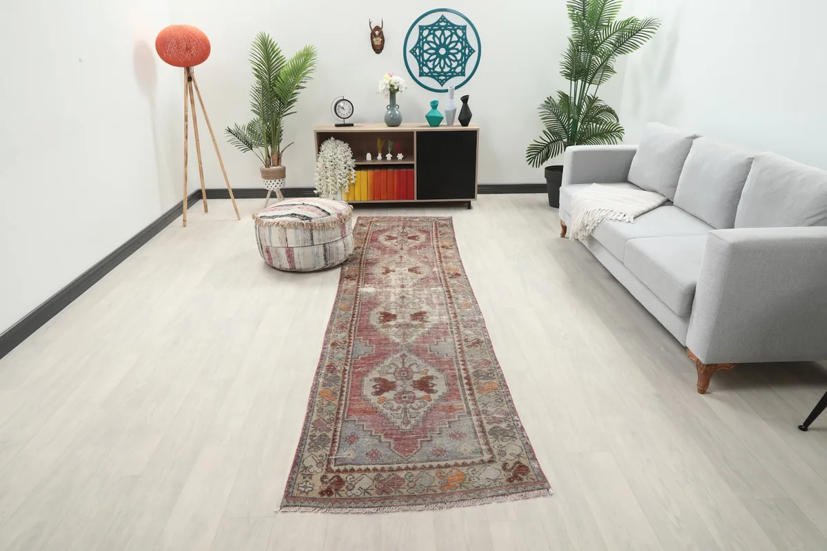 Runner rug displayed in a modern hallway with a gray sofa and light wood floor, showing its full length.