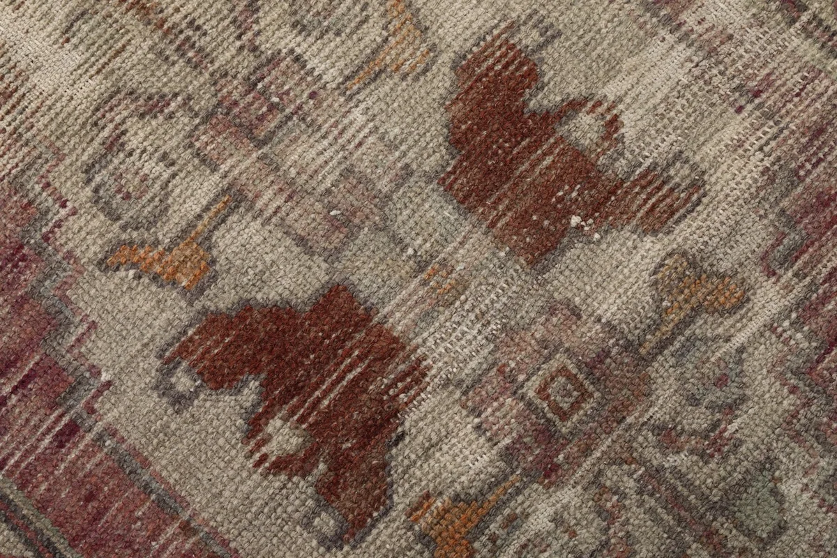 Macro shot of the low wool pile, showing the hand-knotted texture and color variations from wear.
