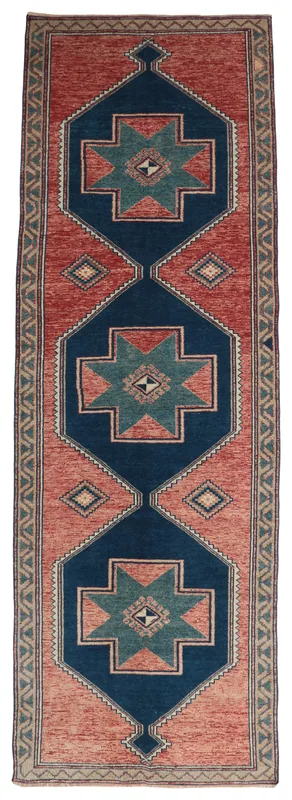 Full top view of the 4'4" x 13'0" Anatolian vintage runner rug with rust field and navy geometric motifs