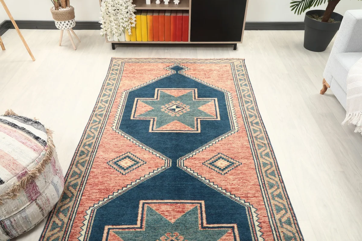 Overhead view of the vintage runner rug in a room, showcasing its full design and colors