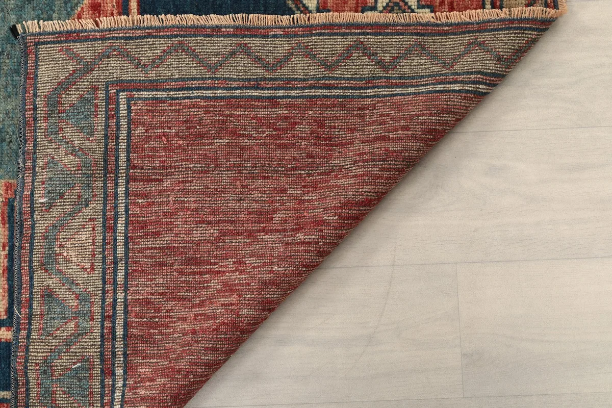Underside view of the rug, showing the dense hand-knotting and cotton foundation