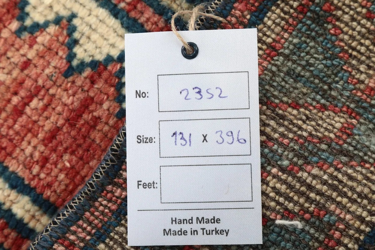 Tag showing the rug's dimensions in centimeters and 'Hand Made in Turkey'