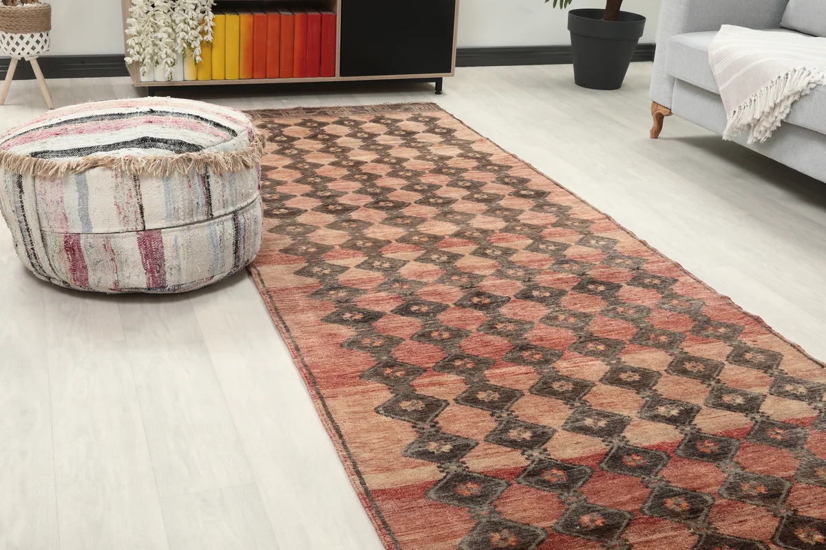 Close-up of the Rust Geometric Tribal Runner in a room, highlighting the pattern