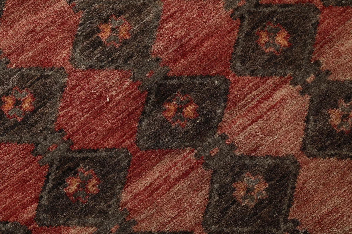 Close-up showing the low pile texture and intricate geometric motifs of the runner
