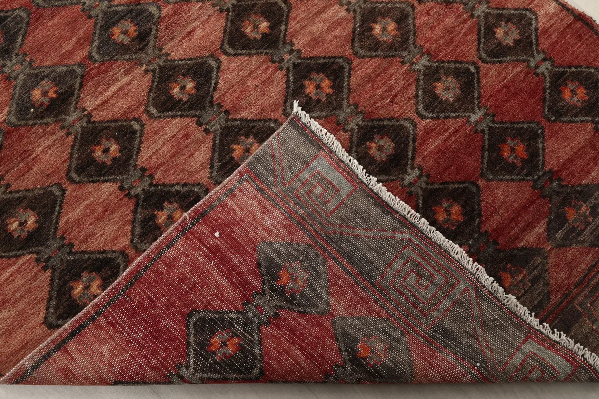 Folded view of the Rust Geometric Tribal Runner, showing the reverse side and knotting
