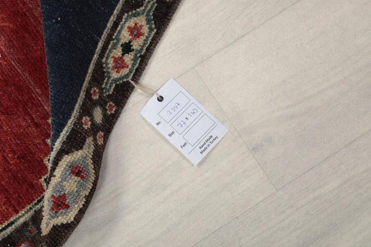 Image showing the product tag with size and origin information next to the rug.