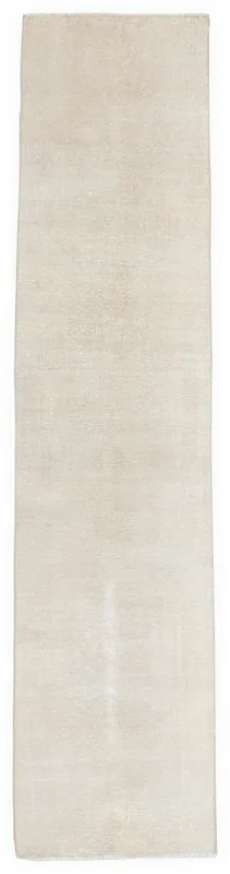 Full overhead view of the beige vintage Anatolian runner rug on a white background.