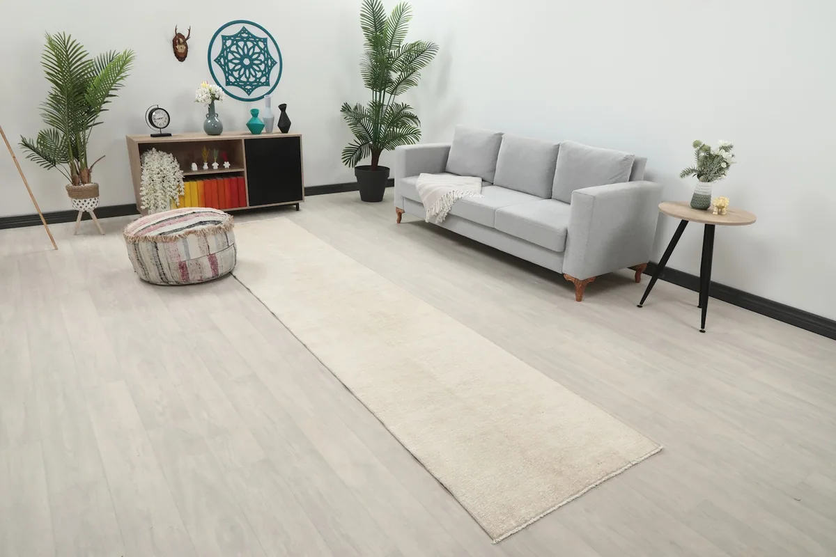 Angle view of the beige runner rug in a living space, showing its length and proportion.