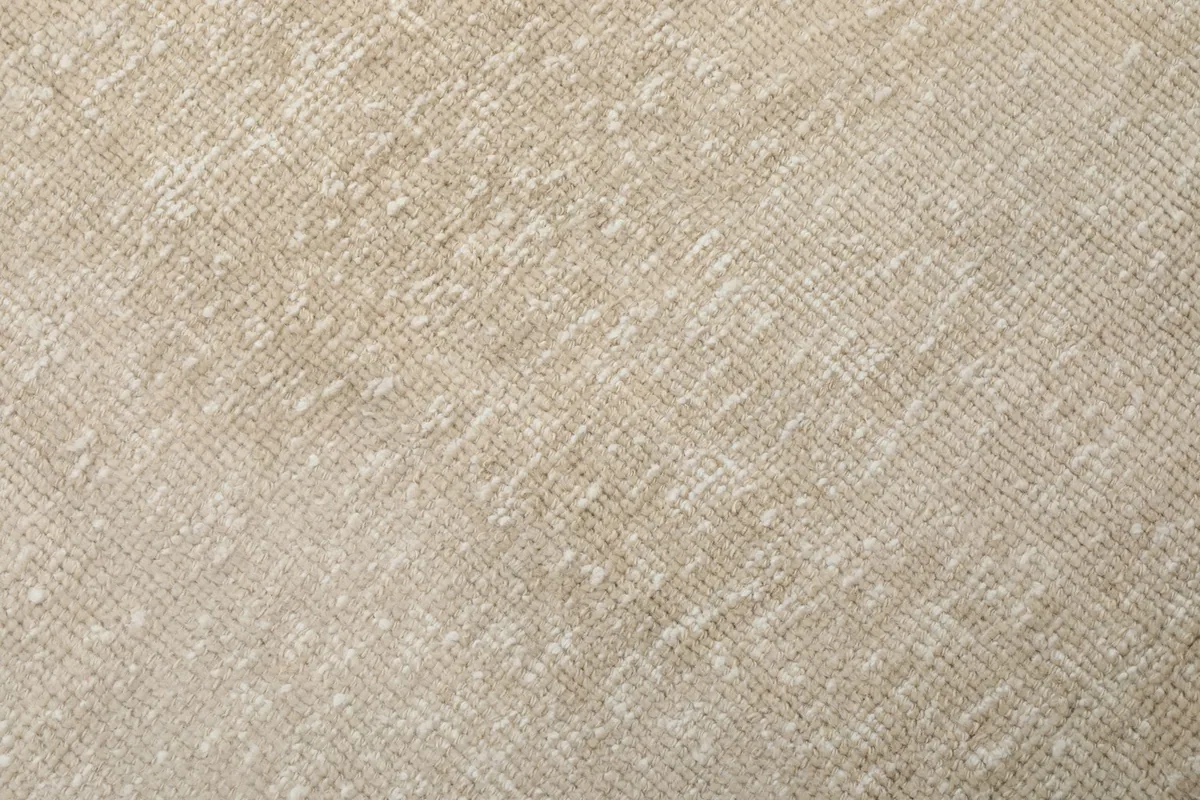 Close-up of the low wool pile and hand-knotted structure of the beige runner rug.