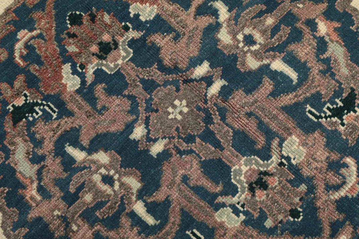 Close-up of the central blue medallion with intricate rose and brown floral motifs