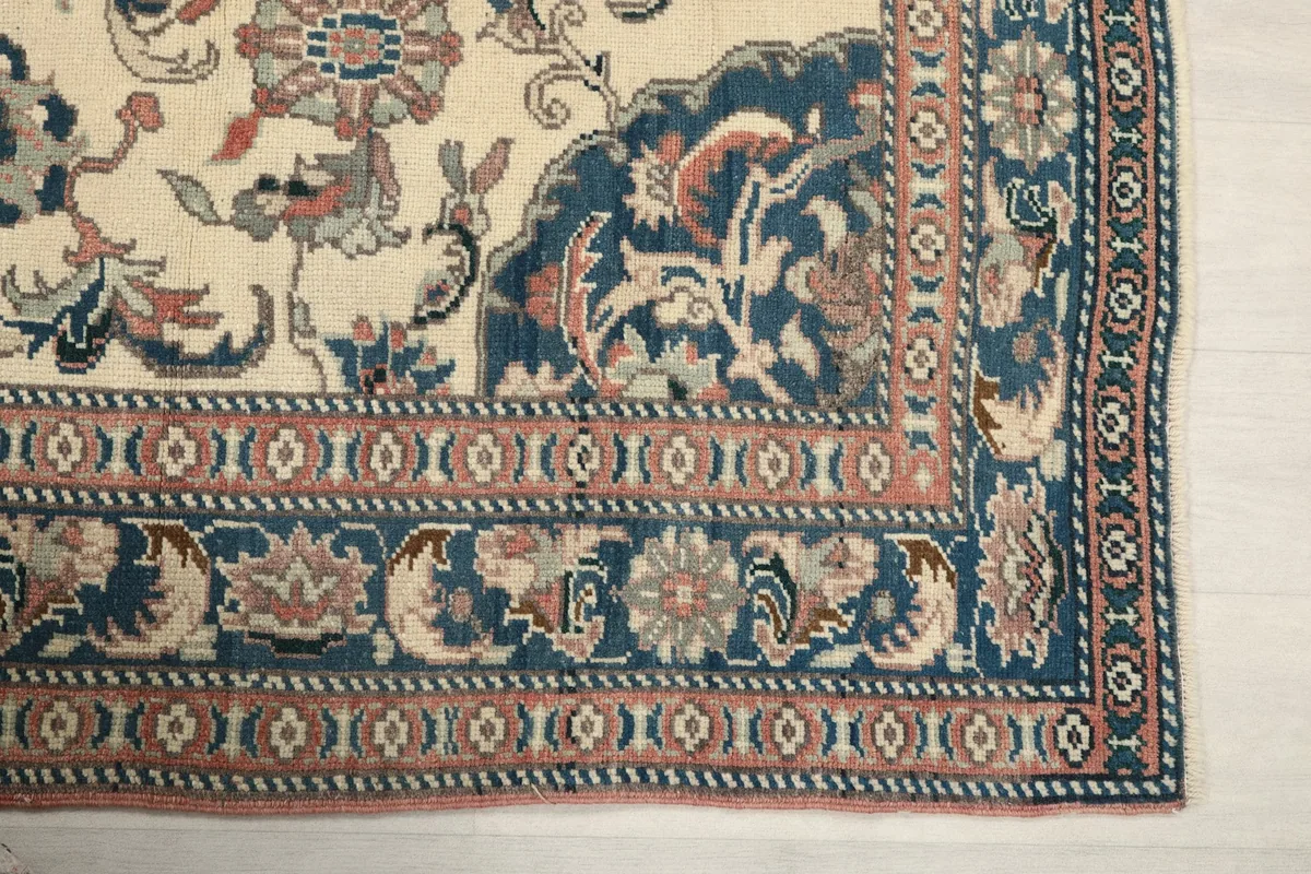 Detail of the blue and rose border with geometric patterns and floral elements
