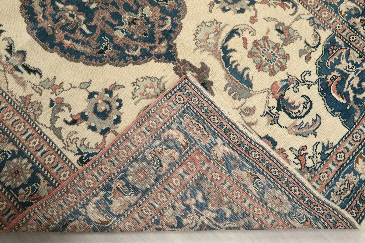 Folded corner revealing the back of the hand-knotted wool pile on cotton foundation