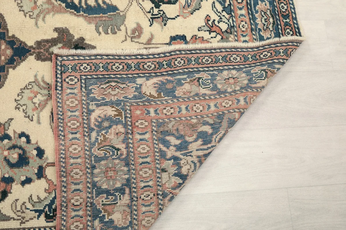 Another view of the folded corner, showing the rug's construction and fringes