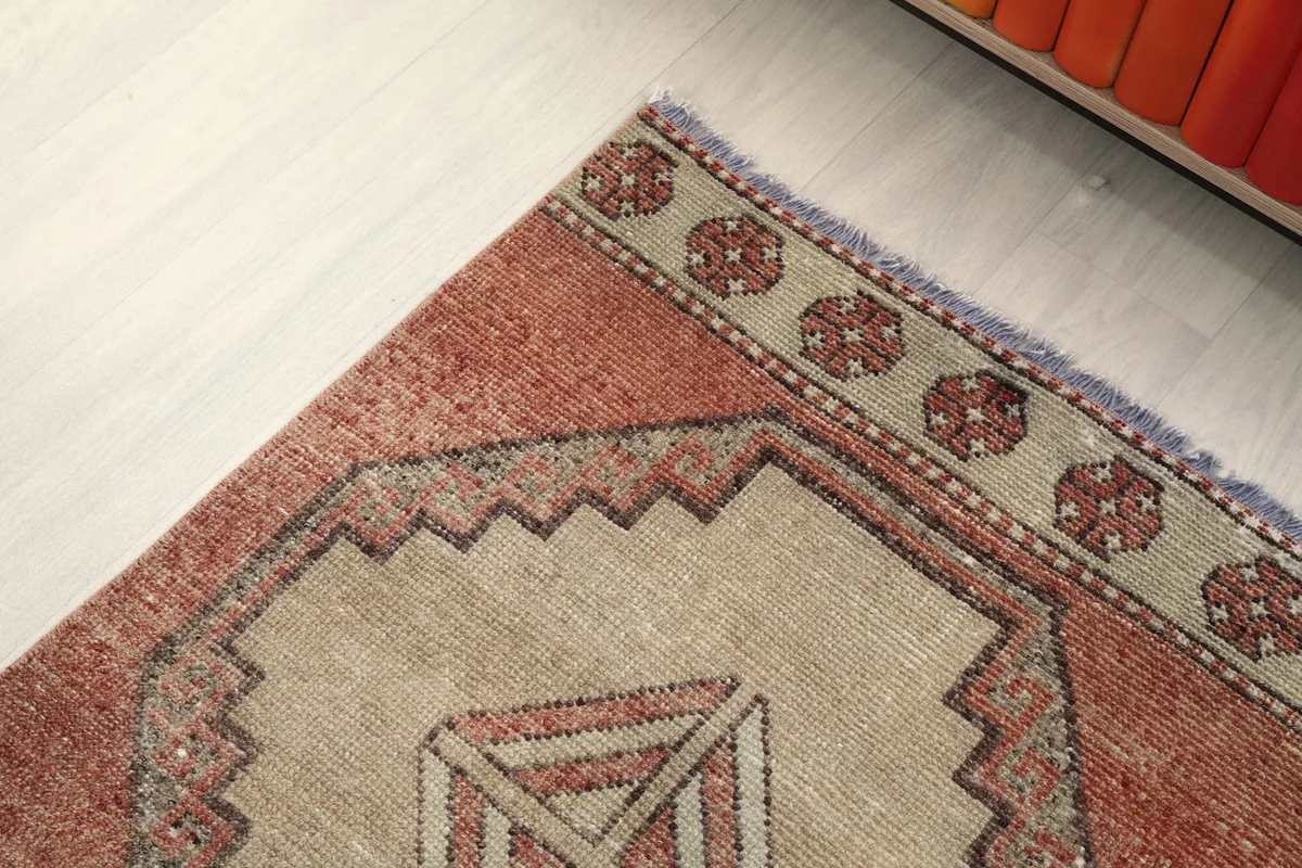 Close-up of the rug's border design and the edge of a geometric medallion