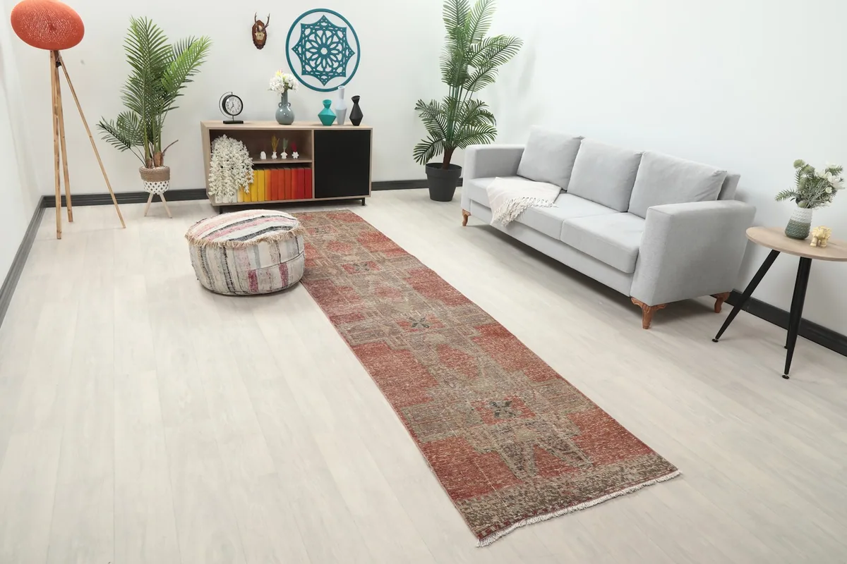 Long view of the rust and gray runner rug extending through a modern living area