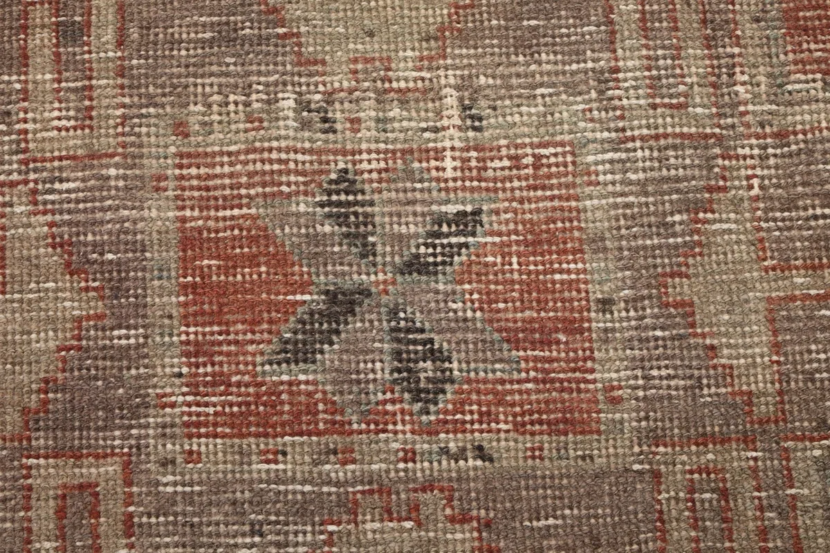 Close-up of the low wool pile, revealing the hand-knotted texture and black details