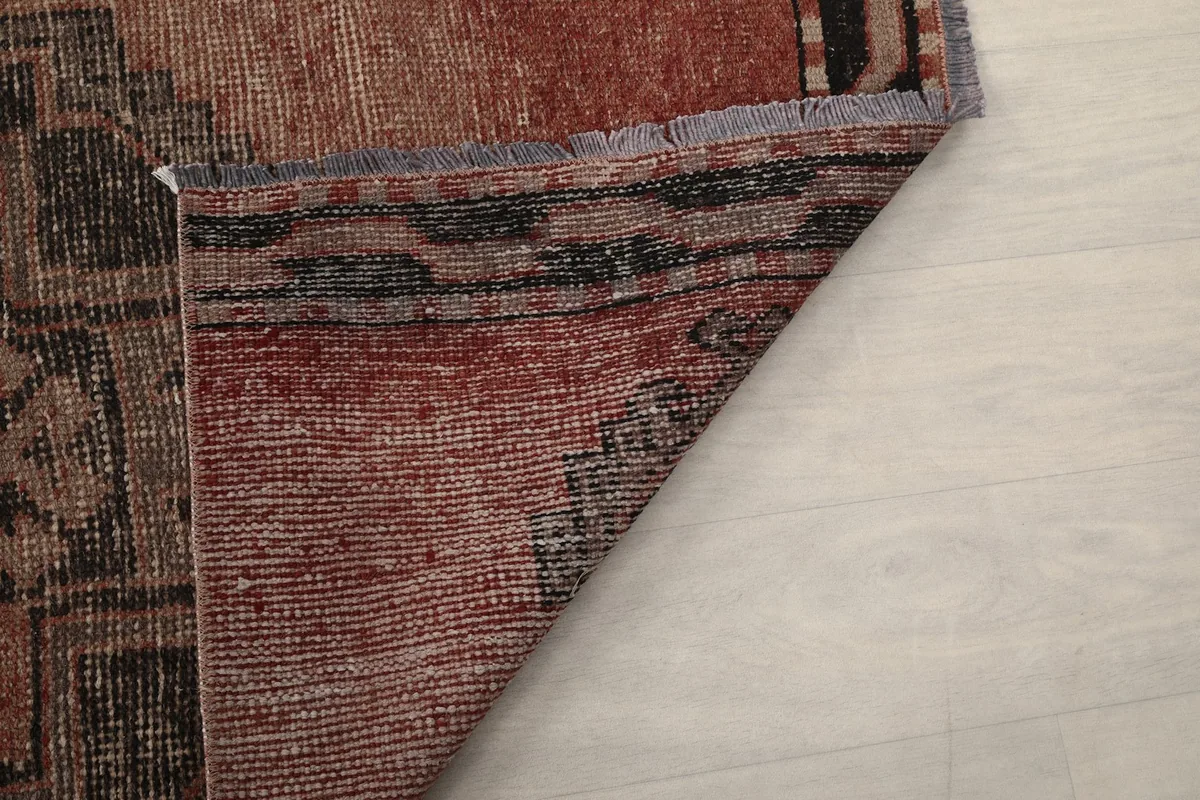 Close-up of the rug's underside, revealing the hand-knotted construction