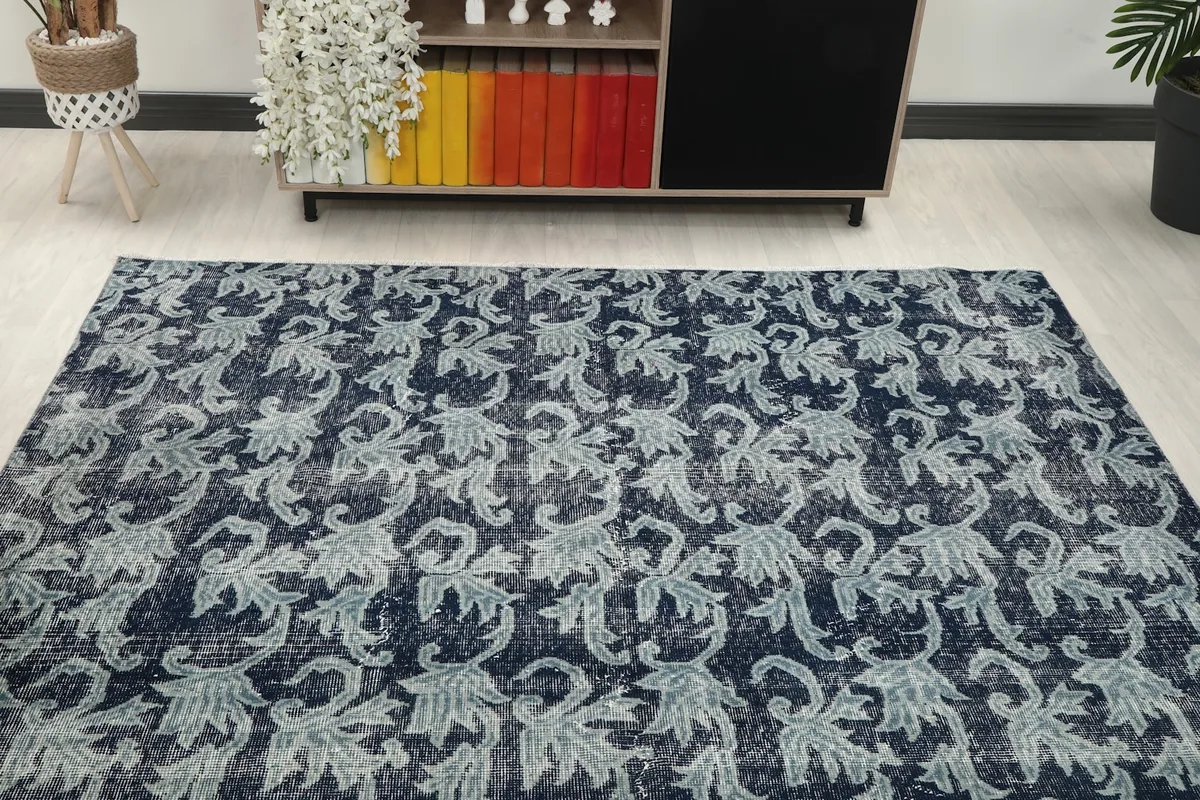 Overall view of the navy and gray rug in the living space, from a slightly elevated perspective.