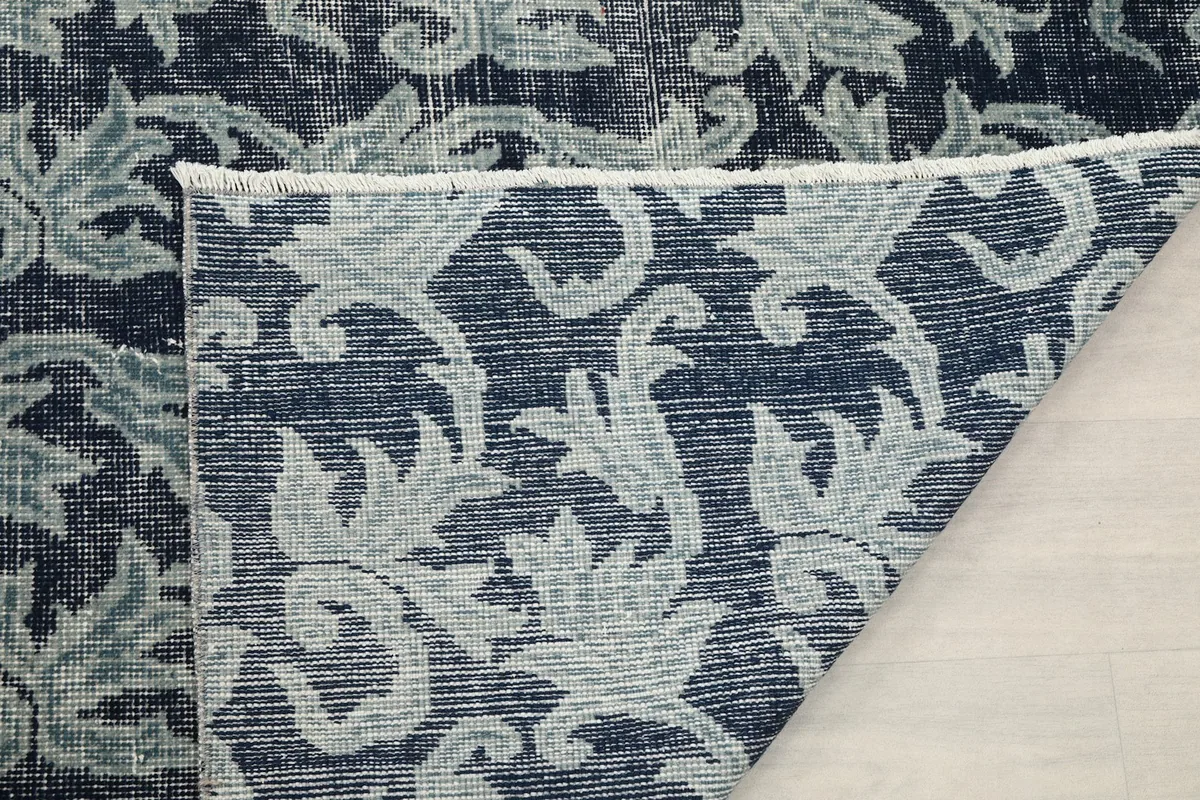 Another folded view showing the back of the rug and the tightly woven cotton foundation.
