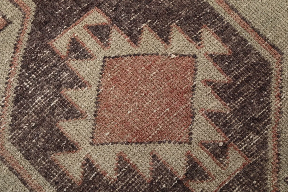 Macro detail of the hand-knotted wool pile showing texture and color variation