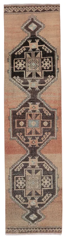 Full overhead view of the rust and black geometric Anatolian runner rug on a white background
