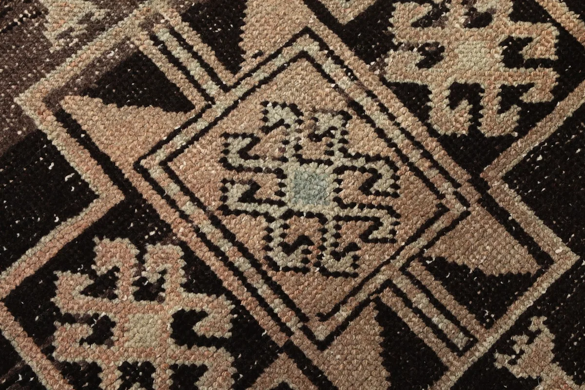Extreme close-up of the hand-knotted wool pile, showing the texture and color variations