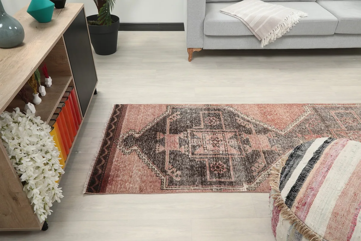 Perspective view of the rug in a room, showing its length and how it complements the decor