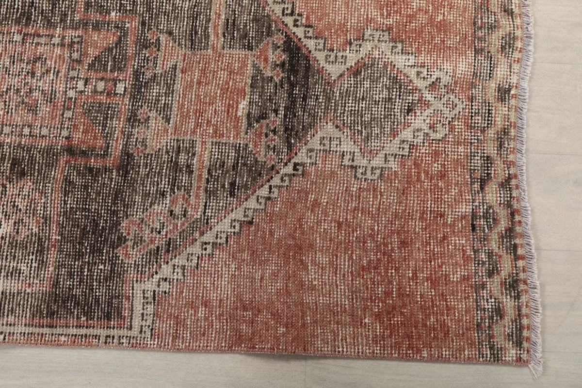 Detail view of the rust field and charcoal geometric motifs with subtle wear