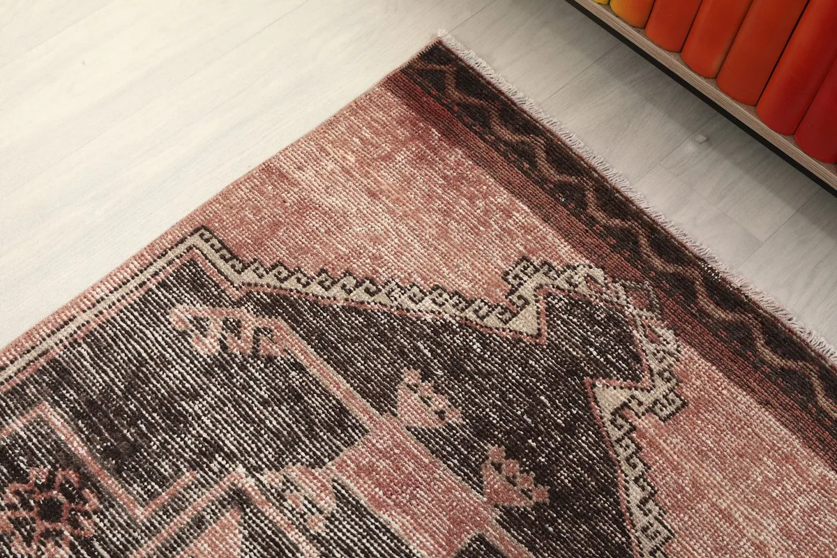 Detail of the rust field and the subtle border pattern along the edge of the runner
