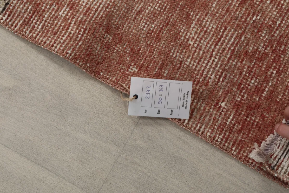 Close-up of the rug's back with a product tag displaying size and origin information