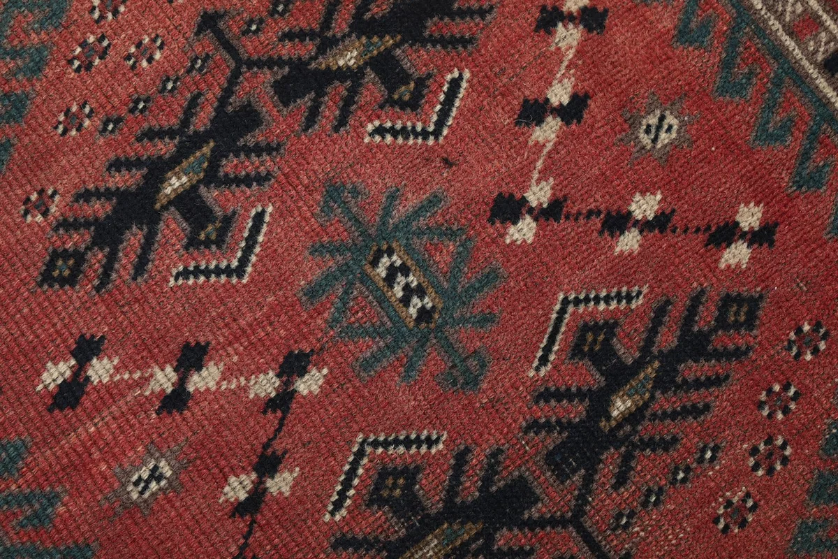 Texture shot of the low wool pile, showing the hand-knotted construction and subtle color variations.