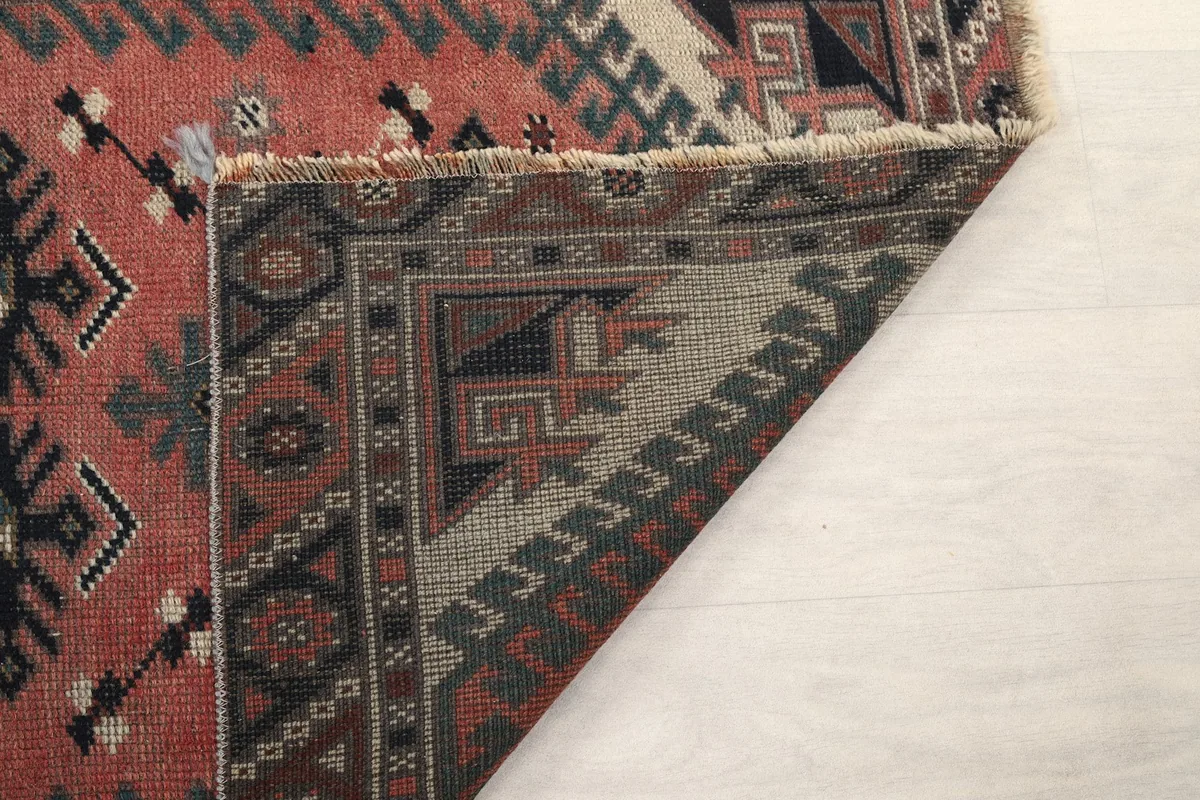 Close-up of the rug's reverse side, revealing the tight hand-knotting and foundation.