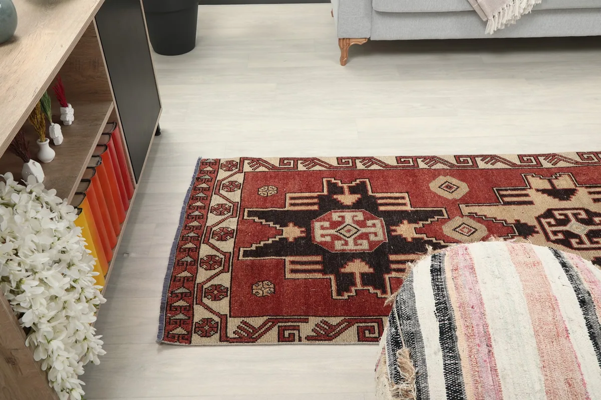 Runner rug stretching alongside a low cabinet and sofa, providing a sense of scale in the room