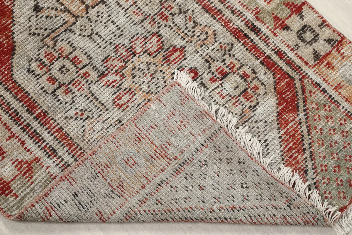 Underside of the rug, folded to show the cotton foundation and hand-knotted construction