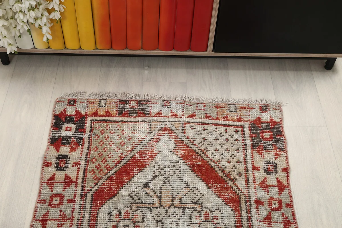 Top-down view of the rug's top half, showing the faded colors and patterns